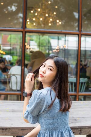 Attractive asian women sitting on wood table in cafe, Happy womenの写真素材