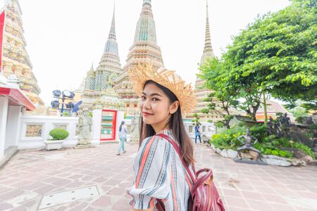 Asian beautiful women travel in buddha temple Wat Pho, Bangkok Thailandの写真素材
