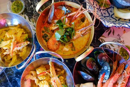 Tom Yum Kung River prawn spicy soup with many seafood boiled serve in restaurant lury bar