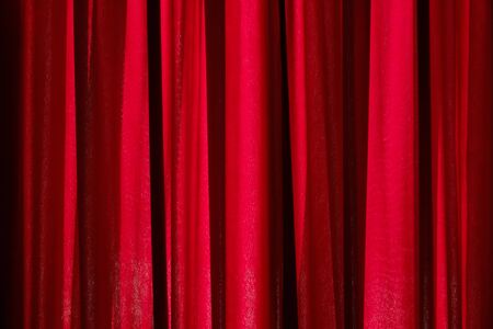 Luxury red closed curtain with light spots in a theater, Red curtainの写真素材