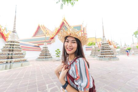 Beautiful asian tourist backpack women walking travel in buddhistm temple pagoda statue travel in....