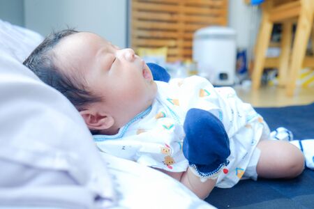 Infant baby boy sleep on blangket day sleepの写真素材