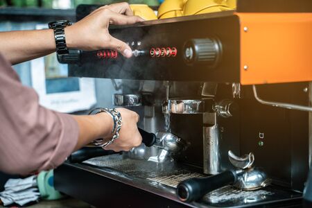 Prepares espresso machine brewing a coffee in coffee shop close upの写真素材