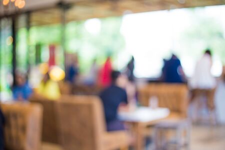 Abstract blurred coffee shop with people food and drink backgroundの写真素材