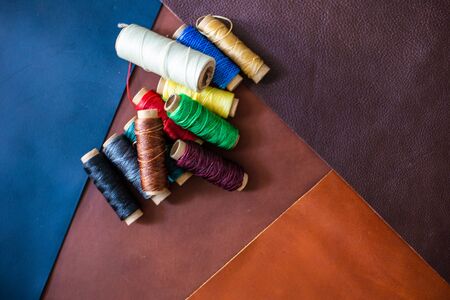 Colorful linin wax thread on leather background craftmanship working industry