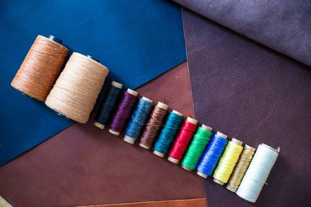 Colorful linin wax thread on leather background craftmanship working industry