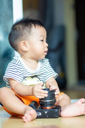 Little boy playing camera in cozy home learning technology