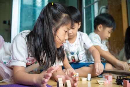 Curious baby boy and girl group studying with toy in modern room little boy and girl educationの写真素材