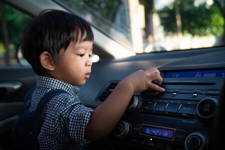 Little boy playing radio control inside car boy travel with family by carの写真素材