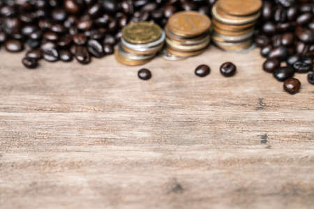 Coffee bean with coin on wood table coffee business concept