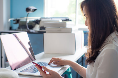 Successful happy girl manager in her own office working with laptop business connection peopleの写真素材