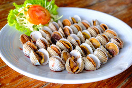 Cockle shell boiled serve with spicy sauce seafood object