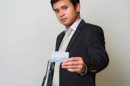 Smart business asian men holding credit card on white backgroundの写真素材
