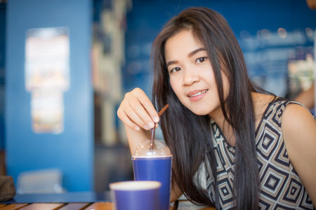 Asian business casual  women drinking hot coffee in cafe, City lifestyle