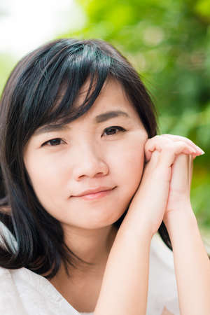 Fashion asian girl outdoor portrait walking in summer park and with long black hair green nature...