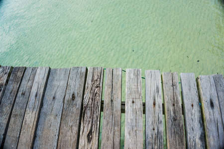 Empty brown wooden platform beside tropical sea beach summer travelの写真素材