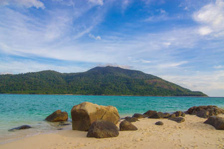 White sand beach tropical sea beach mountain view summer vacationの写真素材