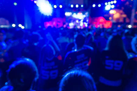 Crowd at concert and blurred colorful stage lights festival Event night timeの写真素材