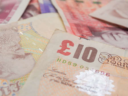 Pile of pound GBP money on white background financial concept