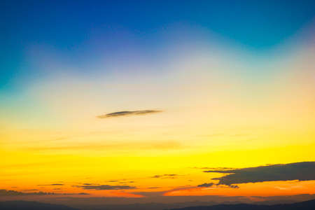 Colorful cumulus sunset sky clouds with sun setting down nature landscapeの写真素材