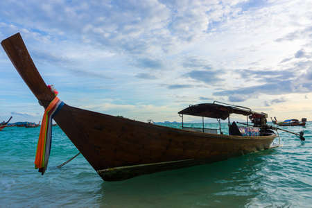 Traditional wooden longtail boat and beautiful sunset sand Beach in Lipe, Thailand.の写真素材