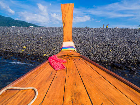 Wooden longtail boat park on rocky sea beach summer vacation in Lipe island Thailand