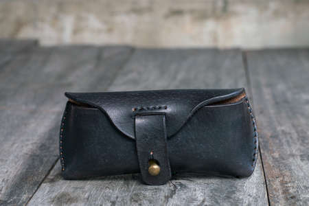 Genuine black cow leather glasses case on wood handmade crafts workingの写真素材