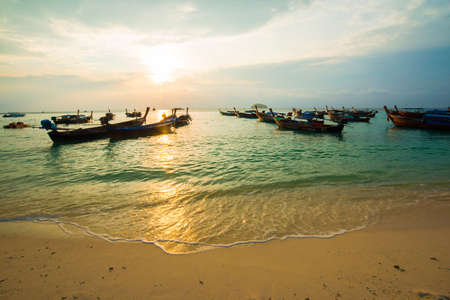 Sea beach morning sunrise colorful sky with boatのeditorial素材