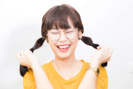 Beautiful asian women portrait long hair smiling wear yellow shirt on white background