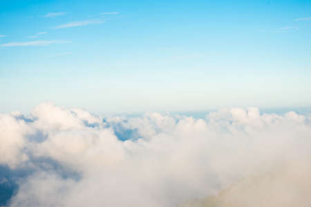 Morning sunrise with fog on top of mountain blue sky vacation trekking winter nature landscapeの写真素材