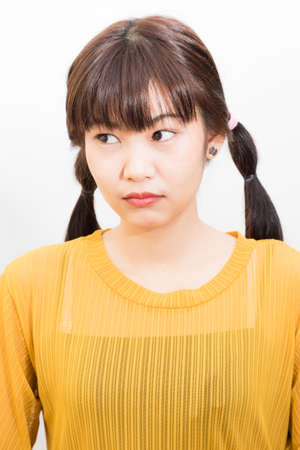 Beautiful asian women portrait long hair smiling wear yellow shirt on white backgroundの写真素材