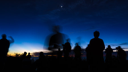 Group of silhouette happy travel friends on background of sunset or sunrise high mountain tourist peopleの写真素材