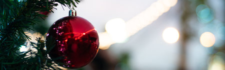 Close up of vintage toned red balls on christmas tree bokeh garlands in the background. New Year...