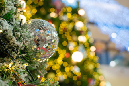 Christmas ball on pine tree brach with bokeh blurred of warm light decorate i supermarket Merry Xmasの写真素材