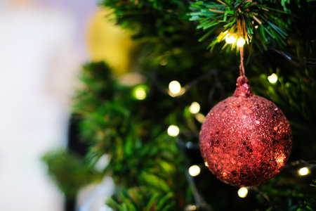 Close up of colorful balls on christmas tree. bokeh garlands in the background. New Year concept.の写真素材