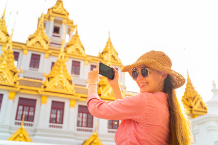 Tourist women take selfie smartphone photo travel in buddha temple in Bangkok Thailanndの写真素材