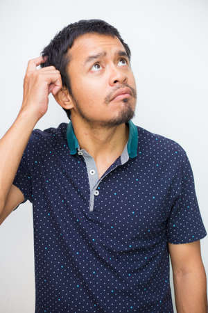 Portrait of handsome beard asian young thoughtful man isolated over white background