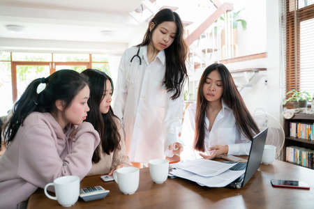 Business designers women analyzing data using computer brainstorming meeting in home officeの写真素材