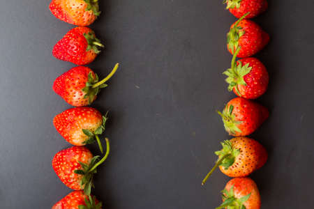 Red fresh strawberry on black plate vitamin fruitの写真素材