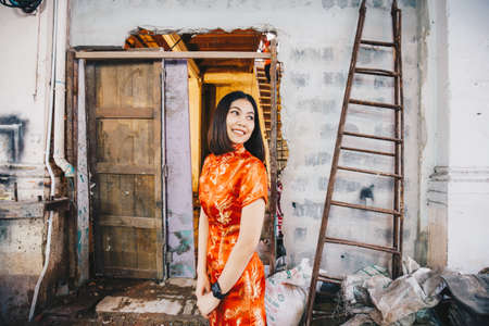 Beautiful chinese women in traditional red dress in Chinatown, Chinese newyearの写真素材