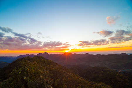 Silhouette sunset in mountains colorful sky with cloud new life conceptの写真素材