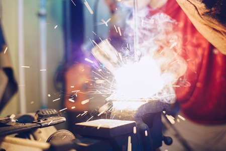 Man hand  Industrial worker welding metal at factory workshop at Steel welding plants