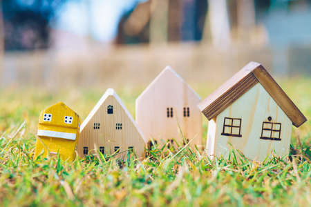 Wooden modern house on green grass with sun light concept image of make your houseの写真素材