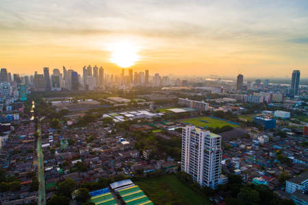 Bangkok downtown city office building with green park sunset aerial view Thailandのeditorial素材