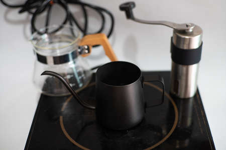 Hot coffee drip on white background with hand mechanic grind coffee and scale home drink