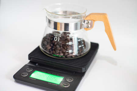 Hot coffee drip on white background with hand mechanic grind coffee and scale home drinkの写真素材