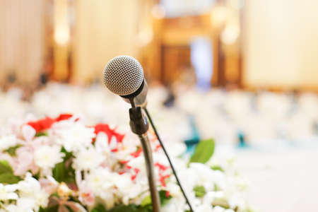 Microphone over the abstract blurred conference hall room business seminarの写真素材