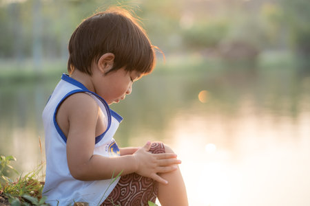 Happy facial face boy playing in tree park sunset light Boy in natureの写真素材