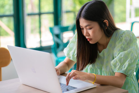 Beautiful women use laptop in modern cafe work from homeの写真素材