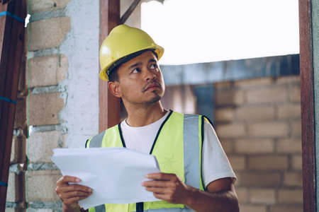 Foreman working in modern house building with notebook innspecture engineer